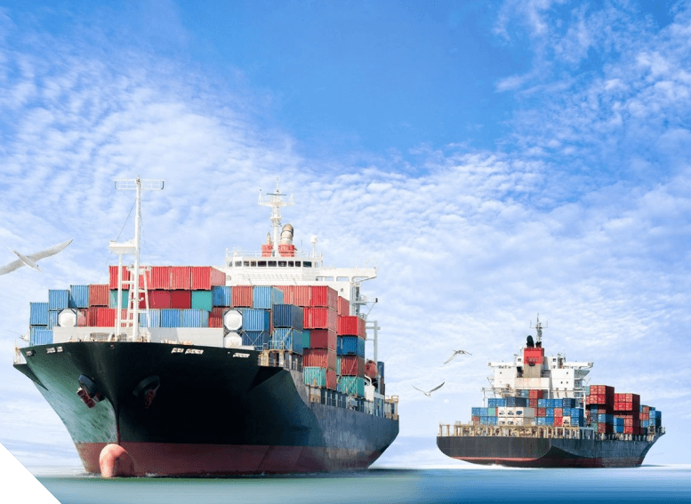 Two large cargo ships in the ocean under a blue sky.