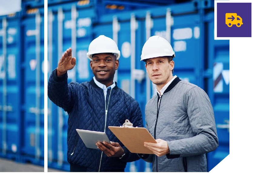 Two men in hard hats holding clipboards and pointing.