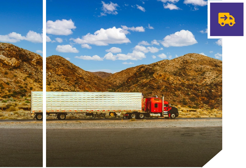 A large truck is driving down the road.