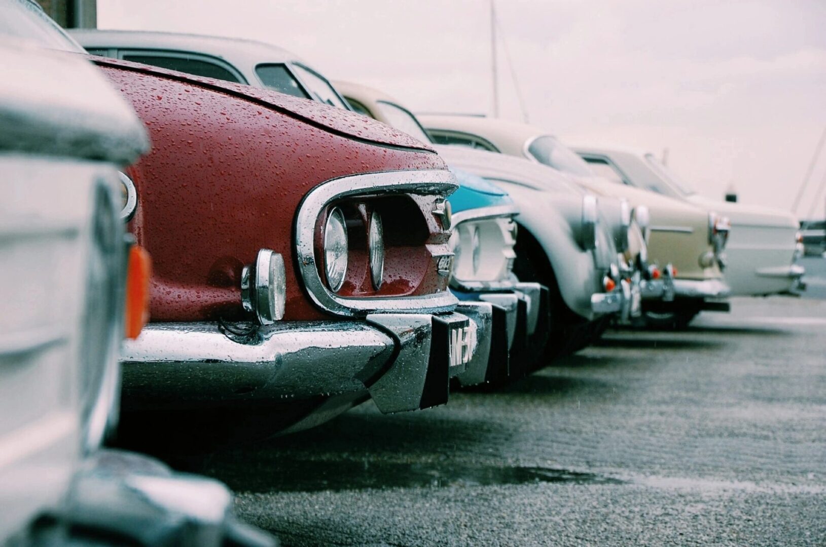 A row of parked cars in a parking lot.